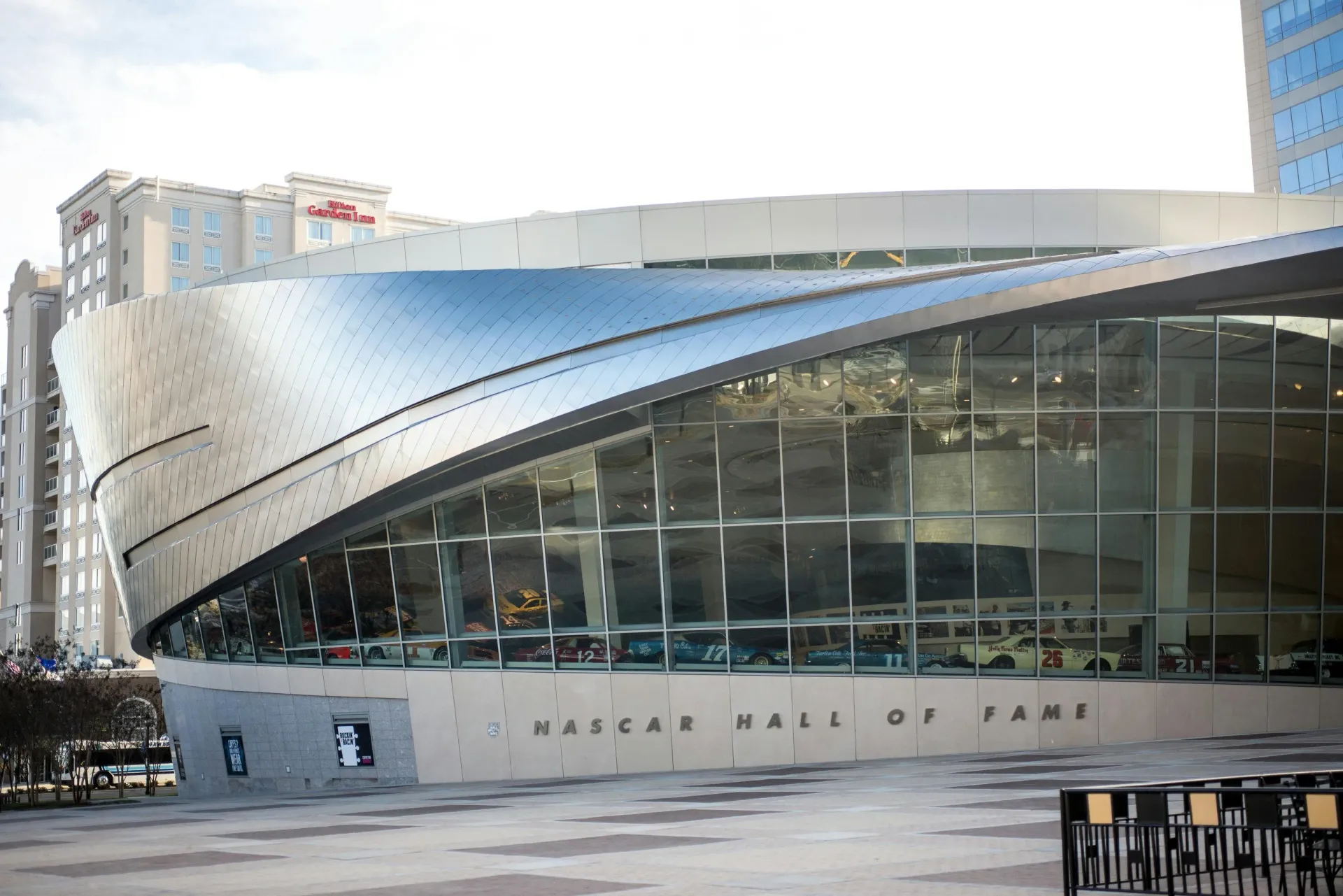 NASCAR Hall of Fame building exterior with cars displayed inside at Catherine 36 Apartments for rent in Charlotte, NC.