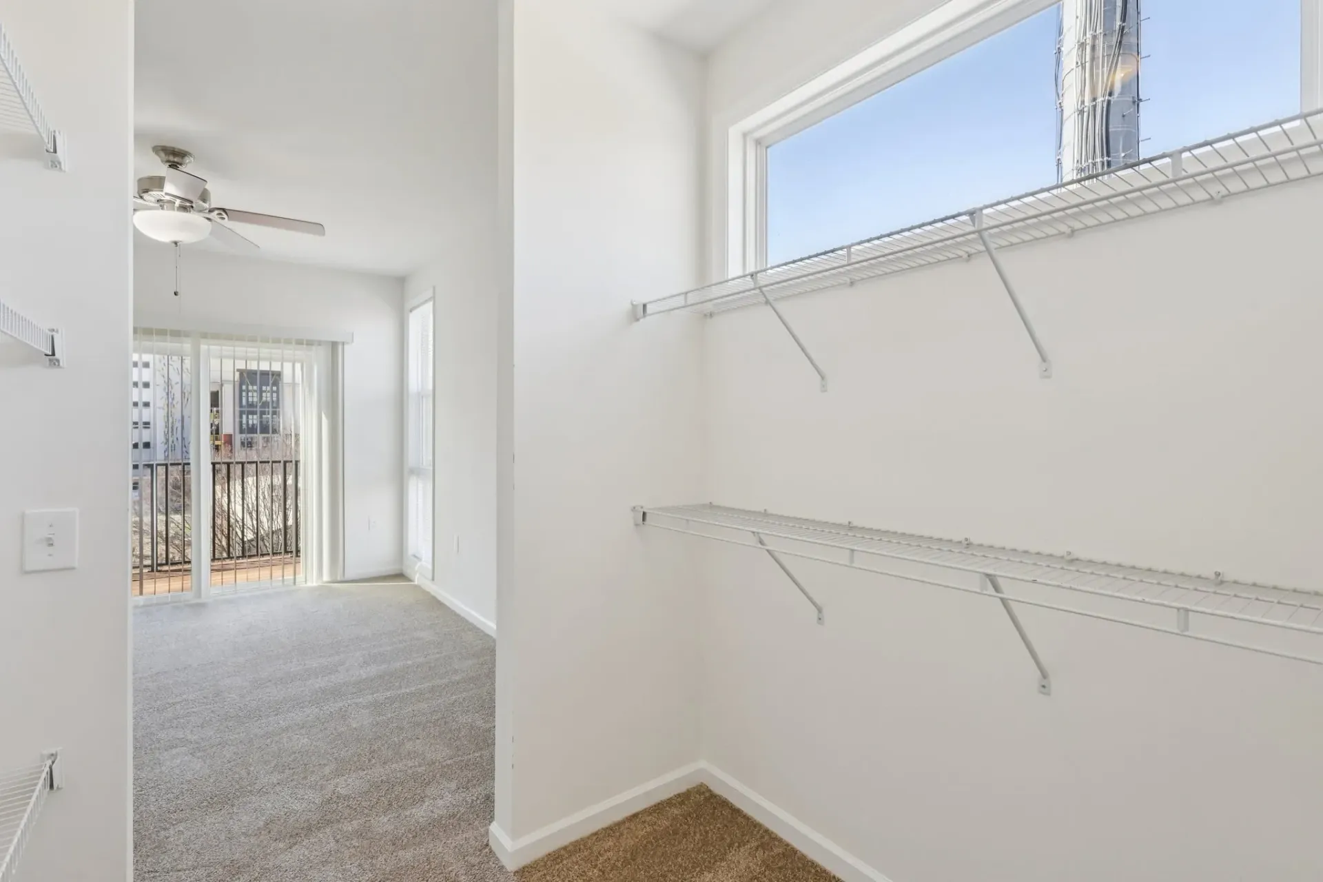 Interior of an apartment with a walk-in closet and a bedroom visible at Catherine 36 Apartments for rent in Charlotte, NC