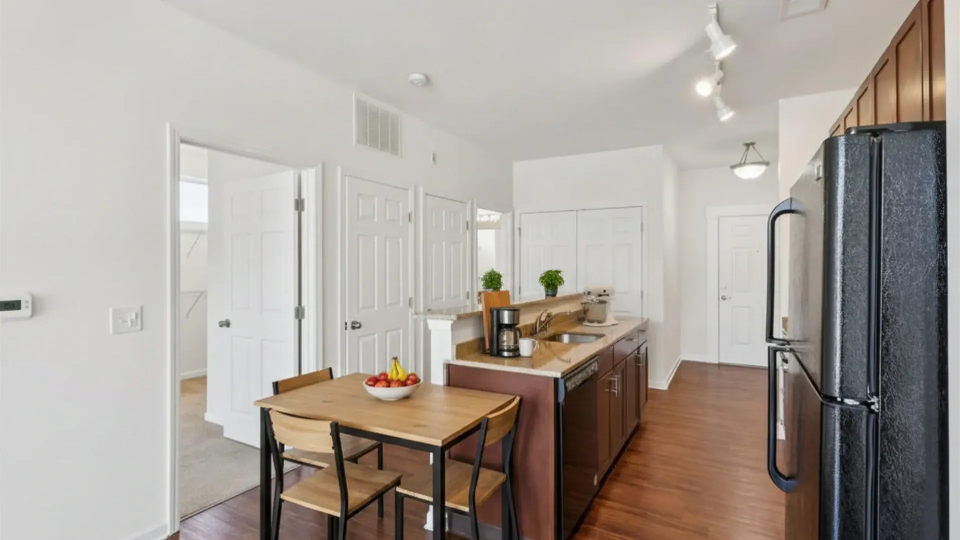 Kitchen and dining area with table and chairs, stainless steel appliances, and granite countertops at Catherine 36 Apartments for rent in Charlotte, NC