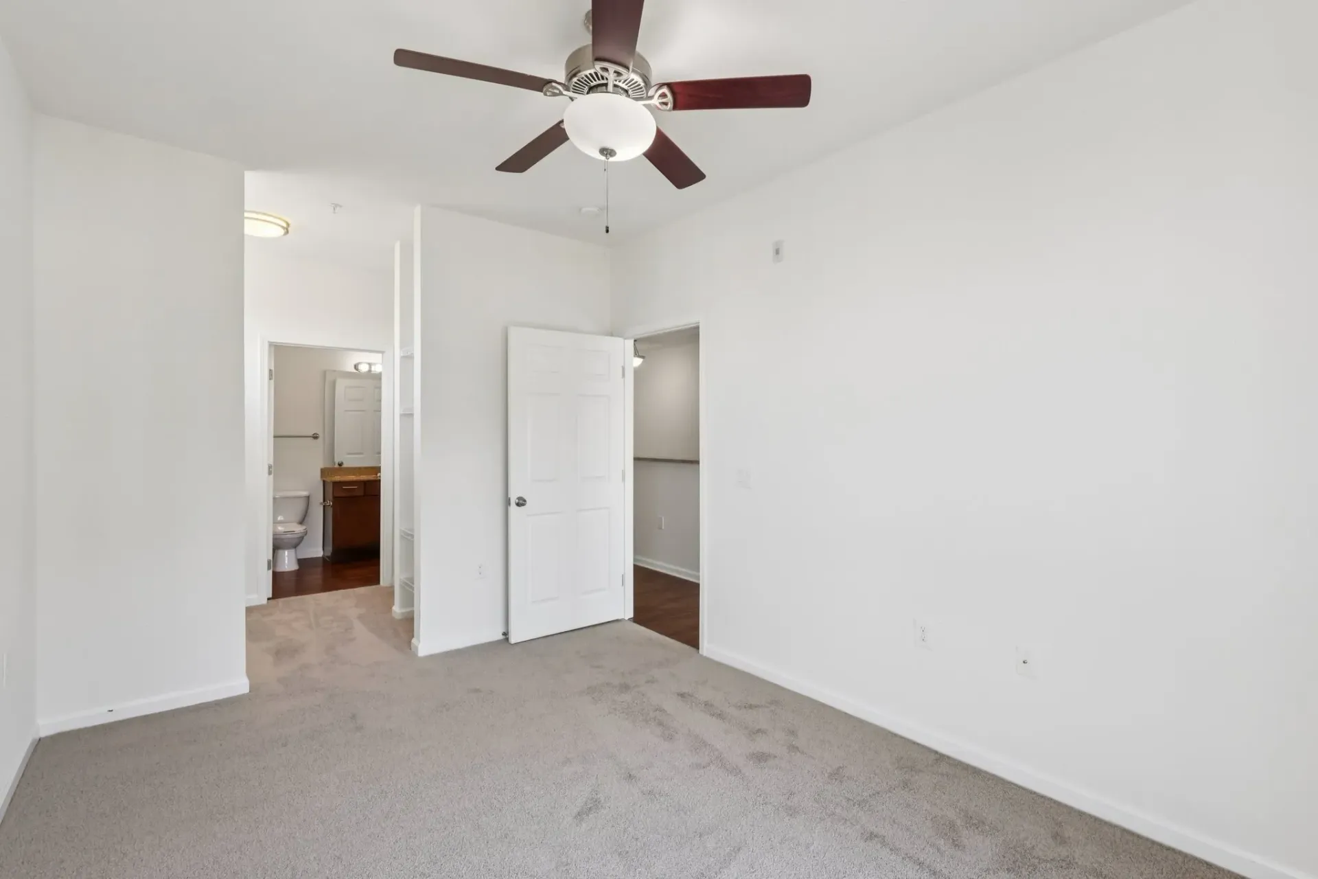 Bedroom with a ceiling fan and a view into the bathroom at Catherine 36 Apartments for rent in Charlotte, NC