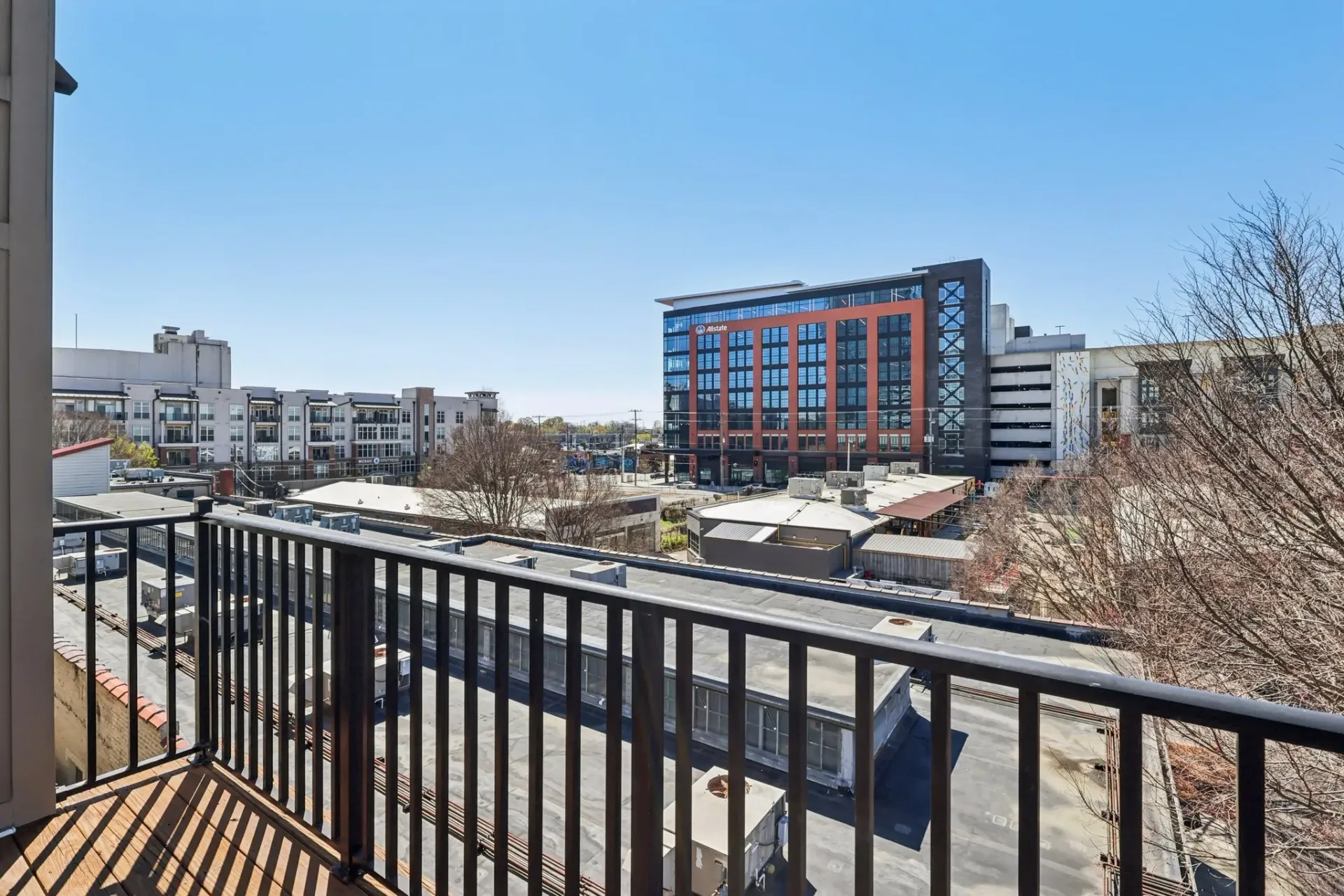 View of city buildings and apartments from a balcony at Catherine 36 Apartments for rent in Charlotte, NC.