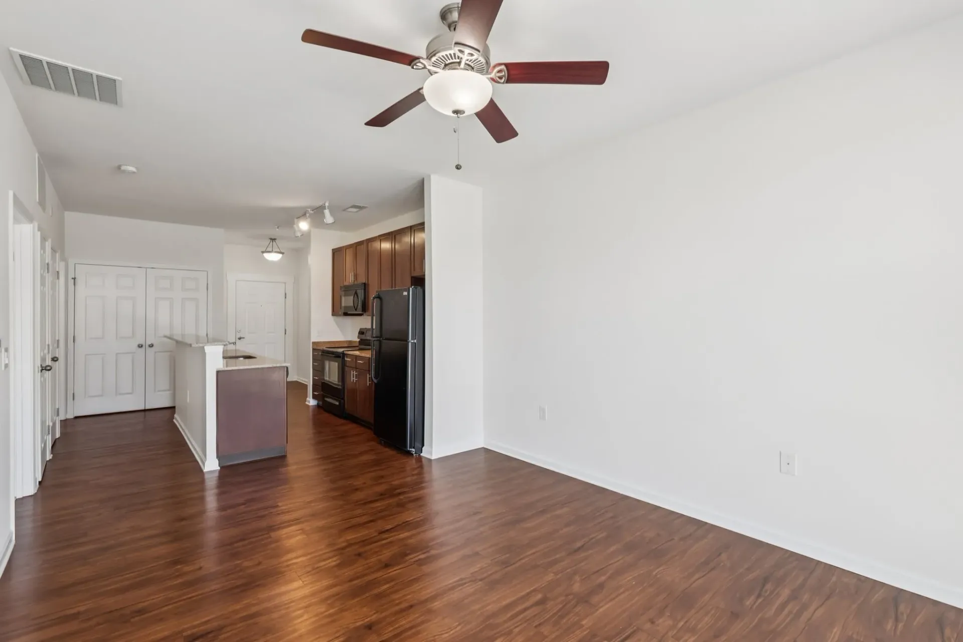 Open concept living area with a kitchen island and kitchen at Catherine 36 Apartments for rent in Charlotte, NC