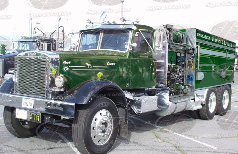 Green vintage semi truck with chrome details parked outdoors at a show