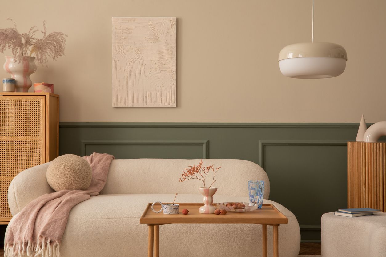 A living room with a white couch and a wooden table.