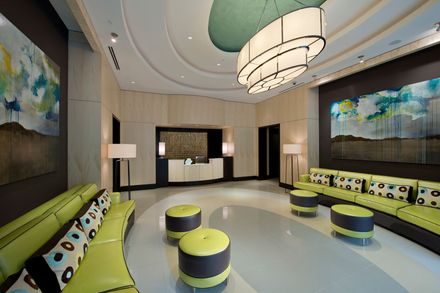 A hotel lobby with a couch and ottomans