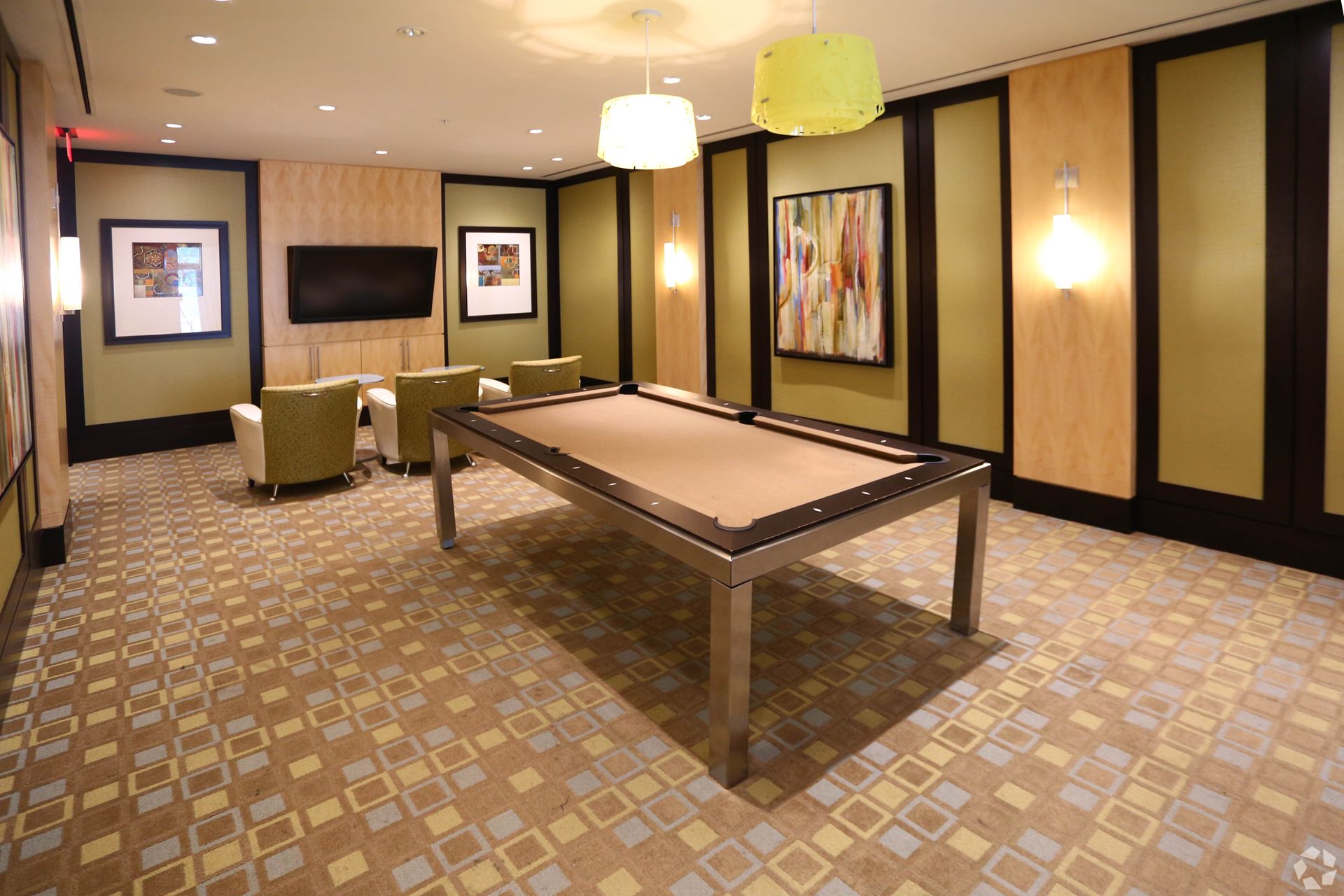 A pool table is in the middle of a room