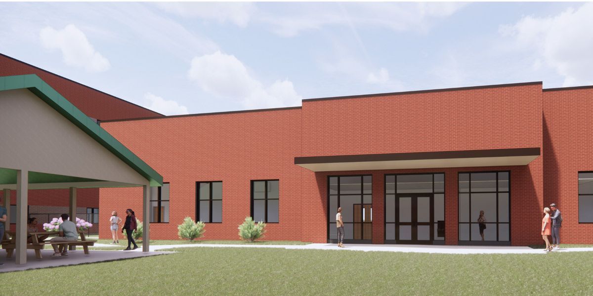An artist 's impression of a brick building with a picnic table in front of it.