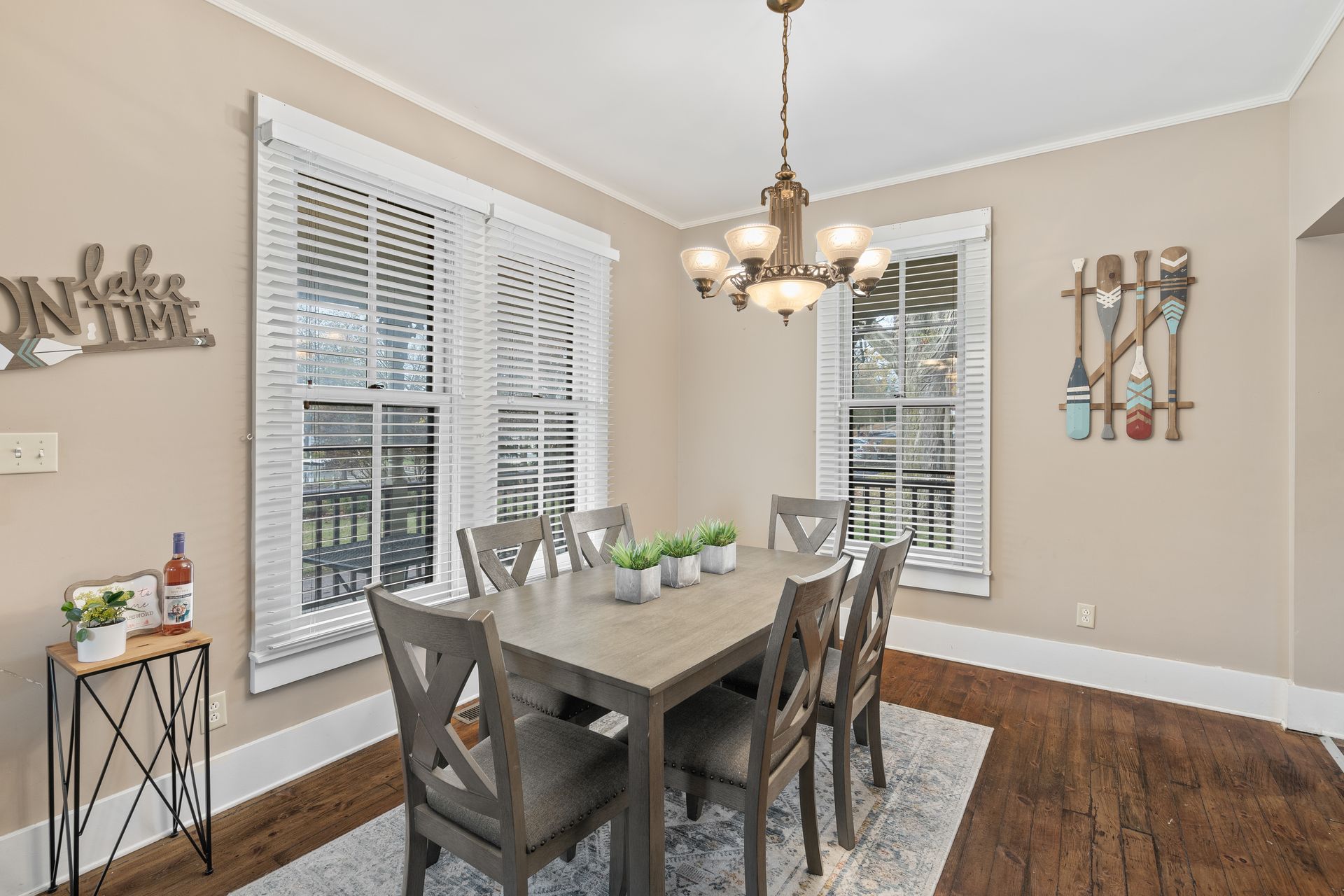 A dining room with a table and chairs and a chandelier.