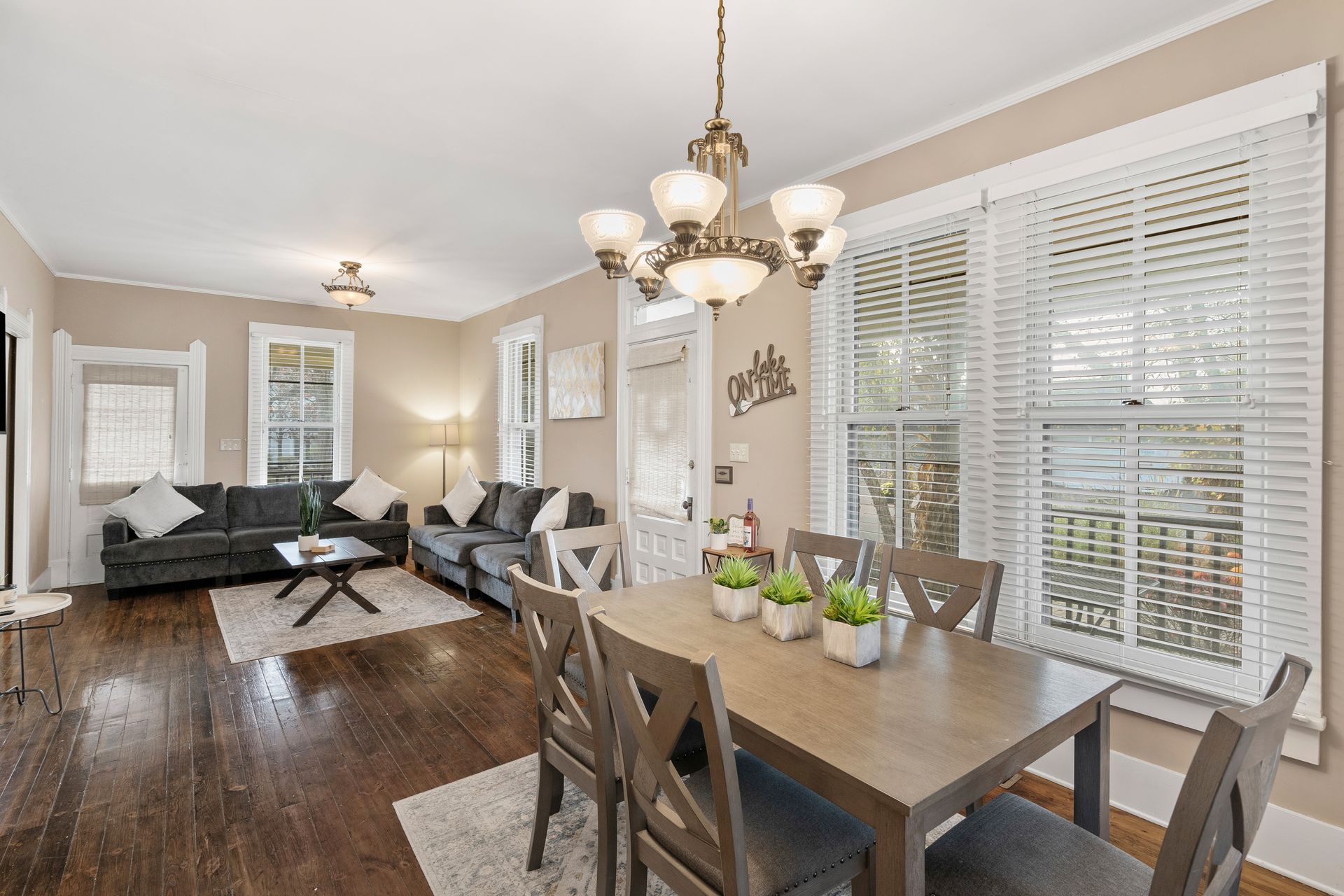 A living room with a dining table and chairs and a couch.