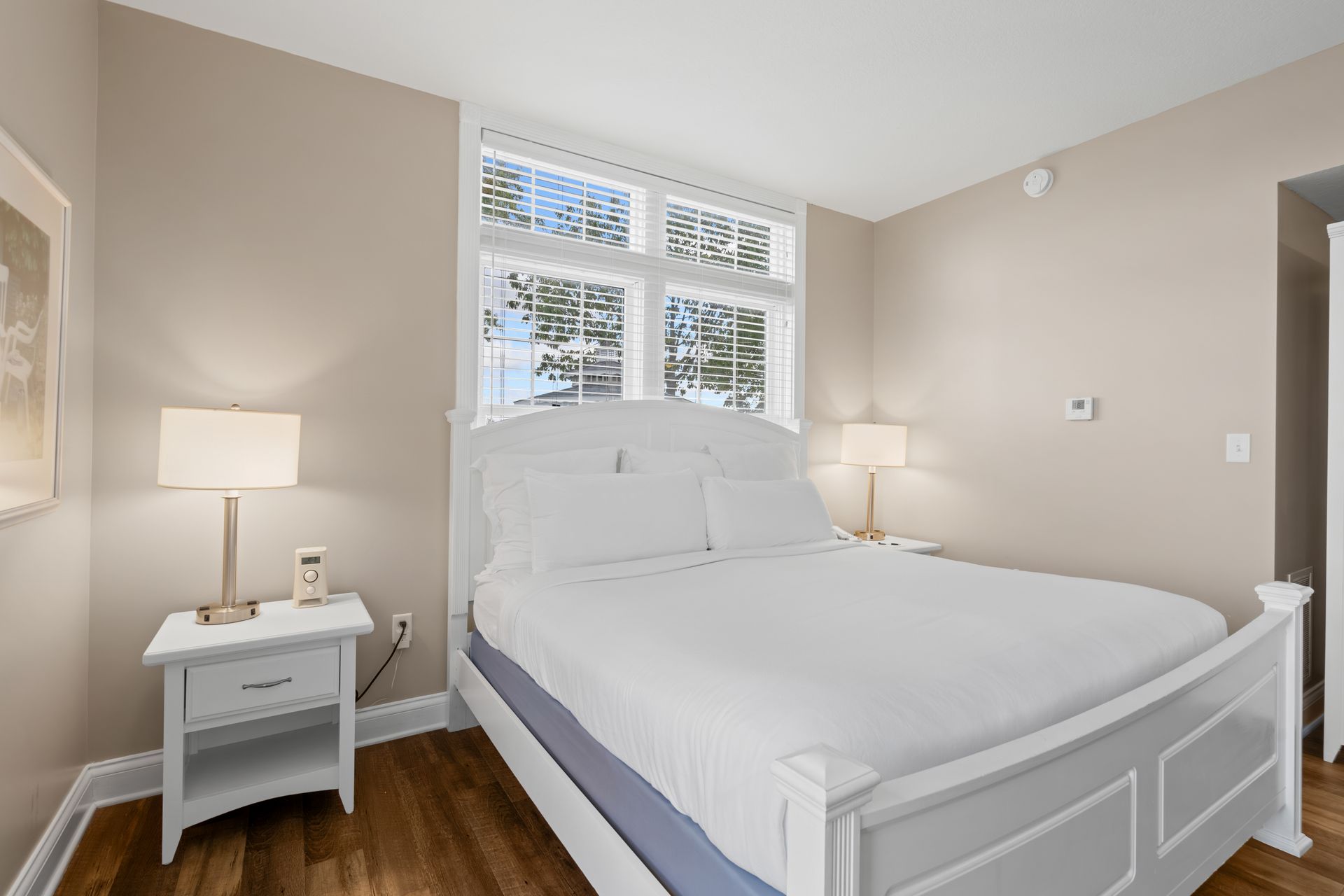 A bedroom with a king size bed and two nightstands.