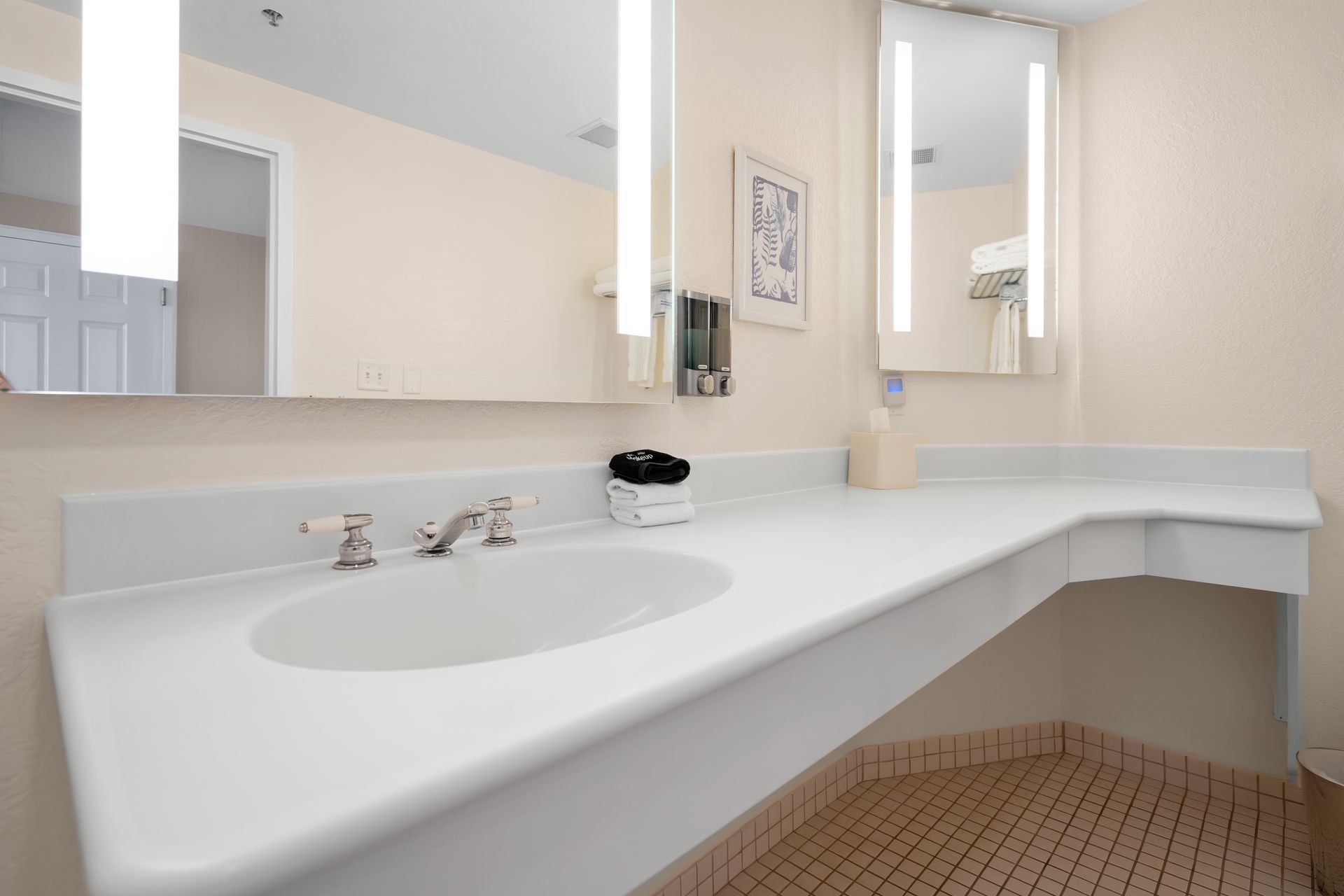 A bathroom with a sink and two mirrors.