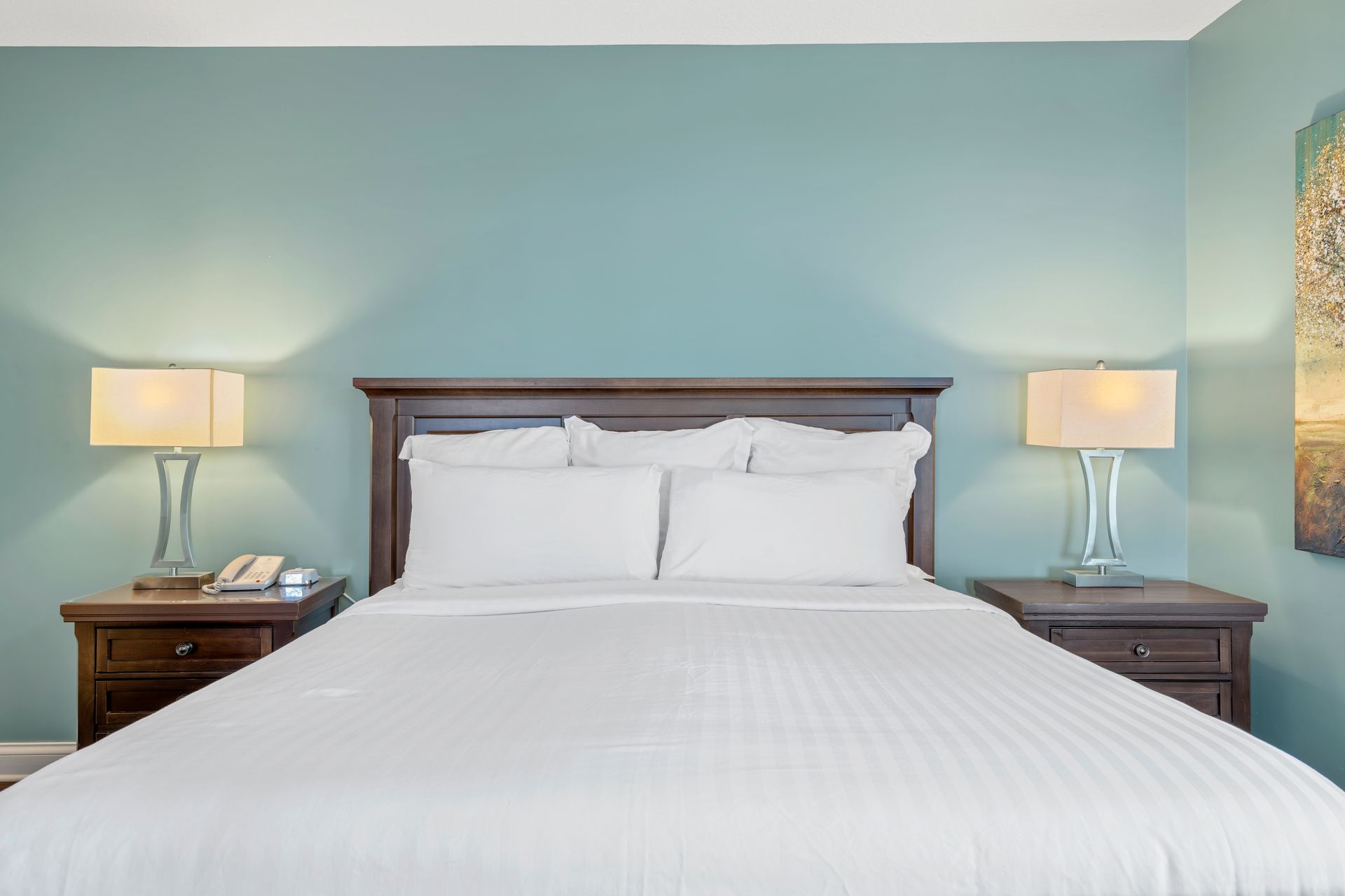 A hotel room with a king size bed and two nightstands.
