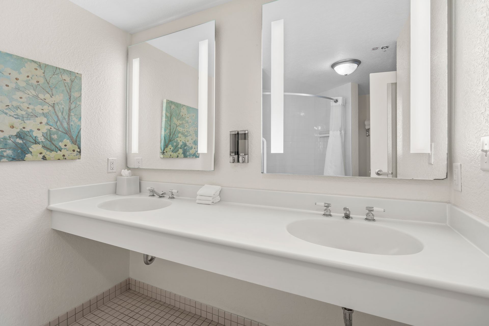 A bathroom with two sinks and two mirrors.