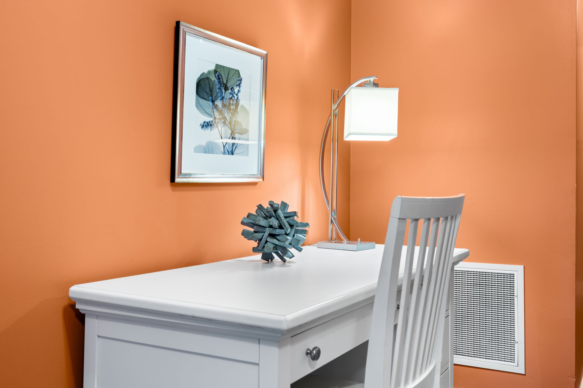 A white desk and chair in a room.