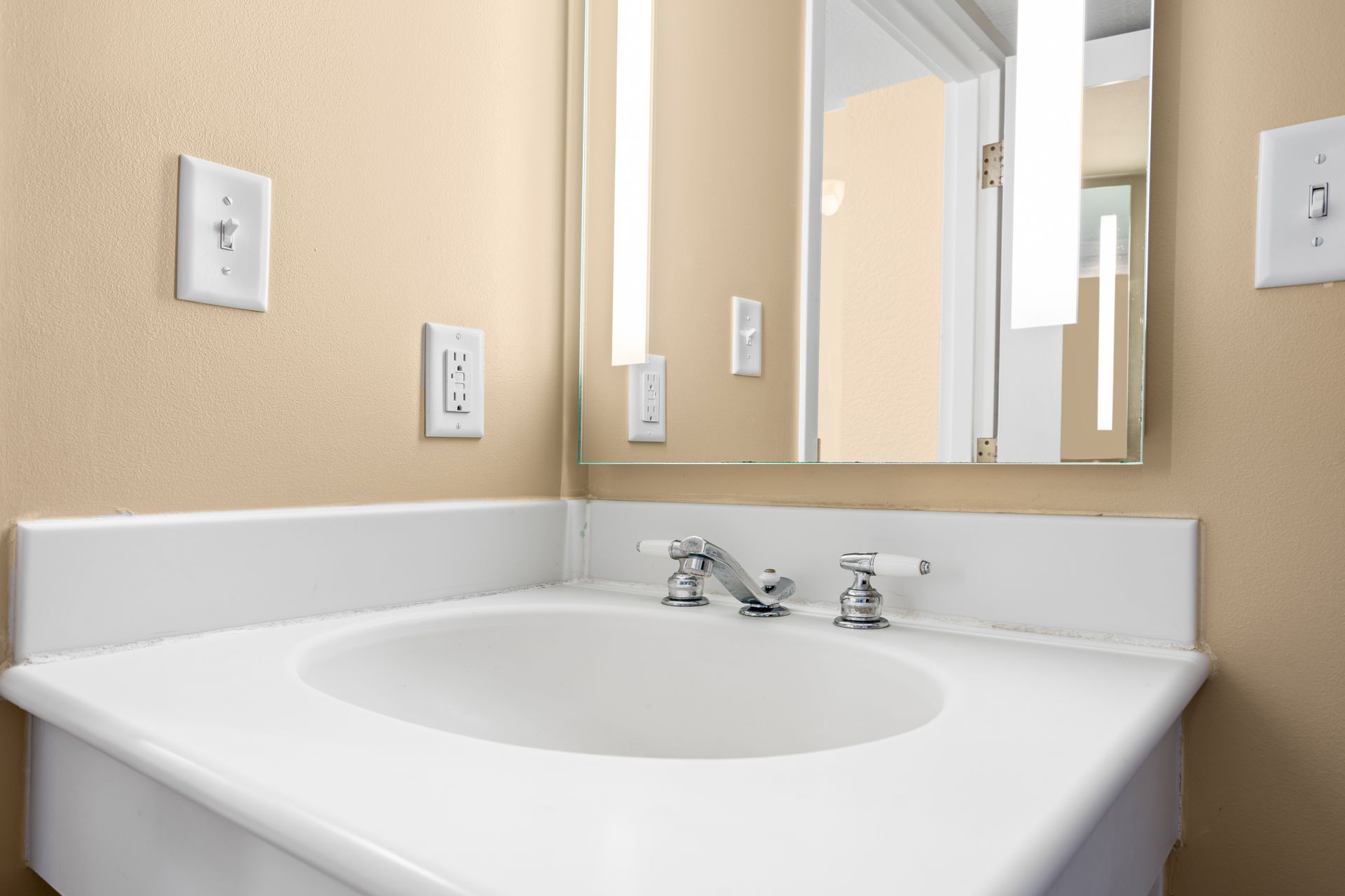 A bathroom sink with a mirror above it