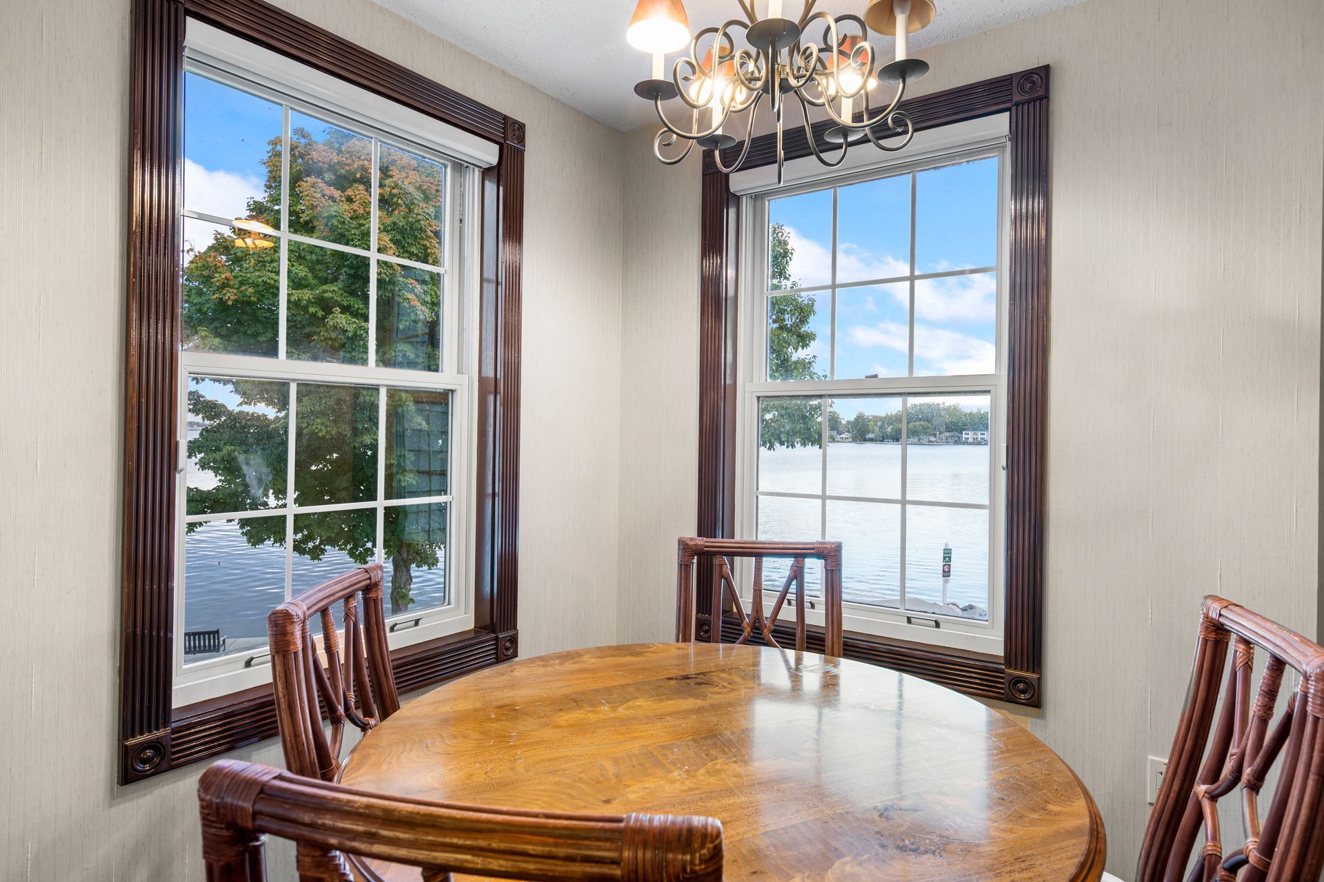 A dining room with a table and chairs and a chandelier.
