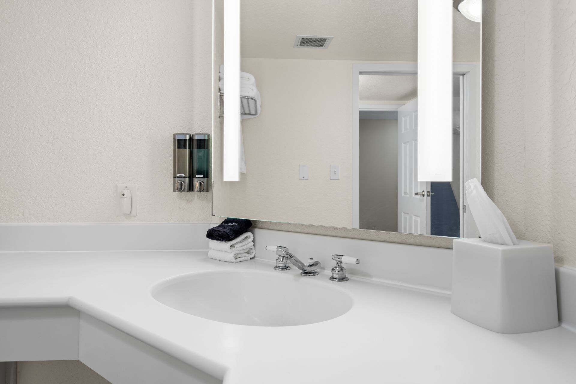 A bathroom with a sink and a mirror.