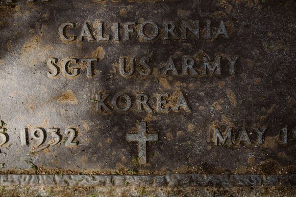 Weathered bronze military grave marker reading “California Sgt. U.S. Army Korea.”