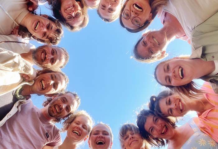 Yoga retreat participants smiling together beneath the Greek sky
