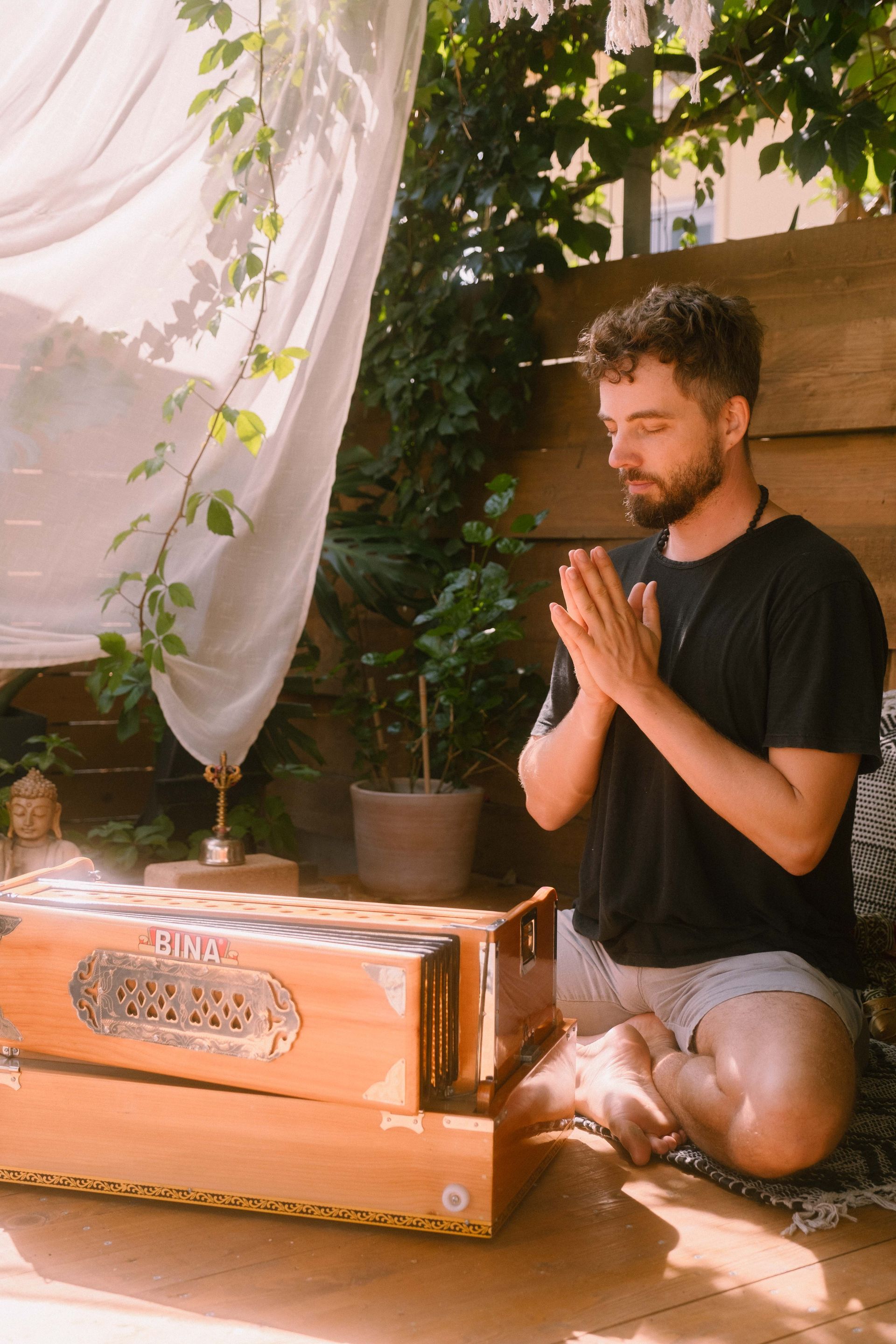 Cedric leading mantra chanting with harmonium at a yoga retreat in Corfu