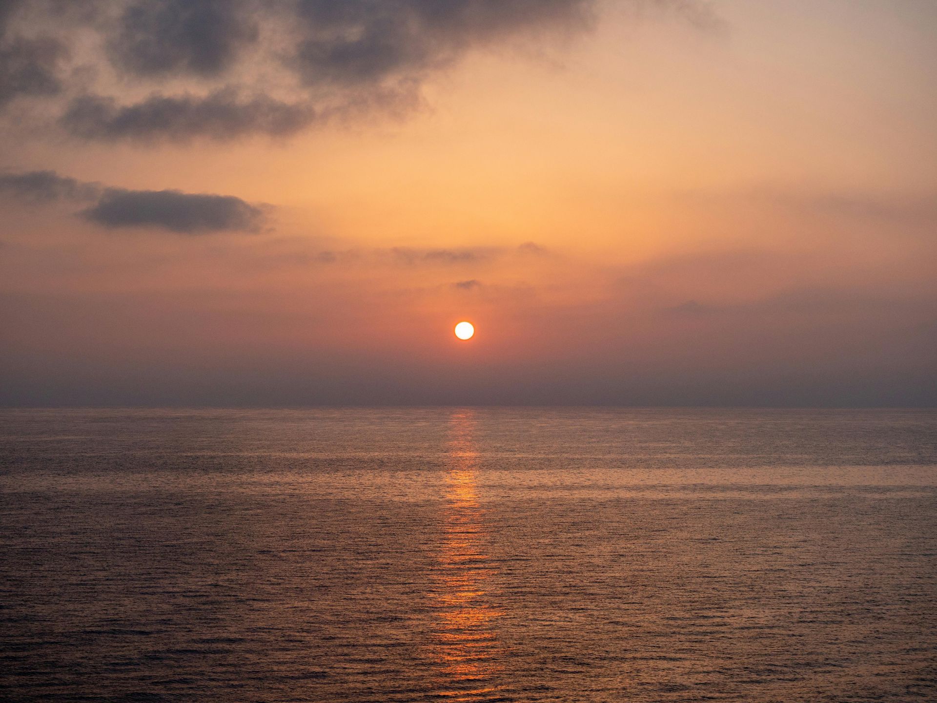 Person meditating at sunset in the peaceful landscape of Corfu, Greece