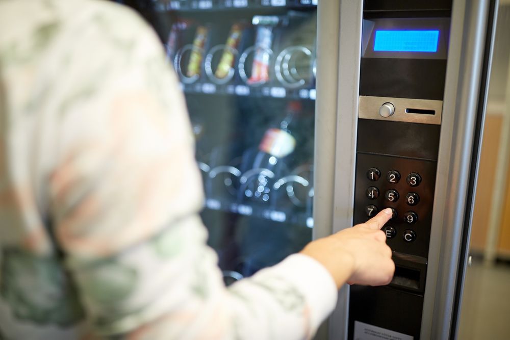 Person Pressing a Number on a Vending Machine — SealTite in Terranora, NSW