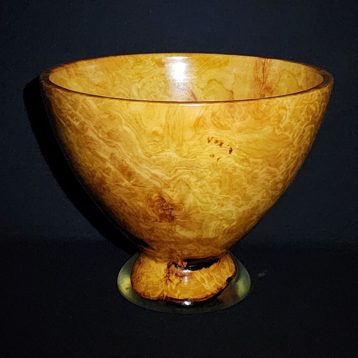 Green resin and wood vase with a bulbous shape.