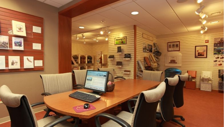 a conference room with a table and chairs and a computer on the desk
