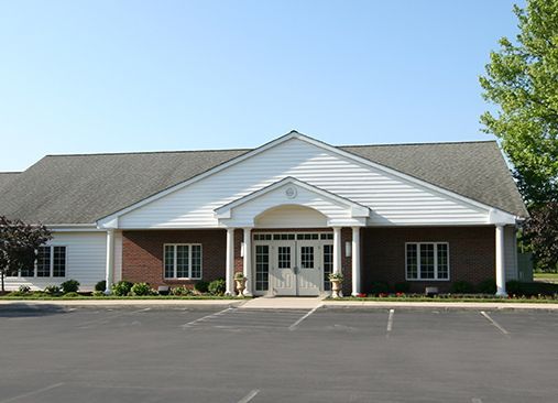 a large brick building with a parking lot in front of it