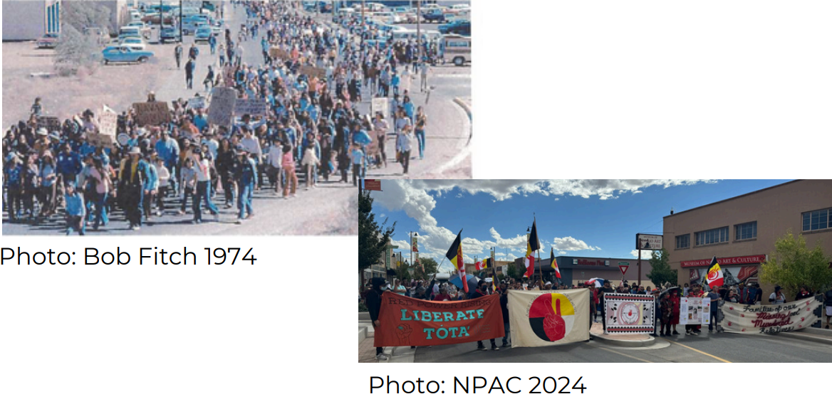 A large group of people are walking down a street.