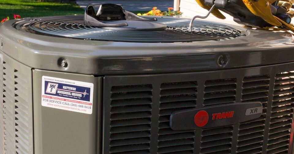 A trane air conditioner is sitting on top of a truck.