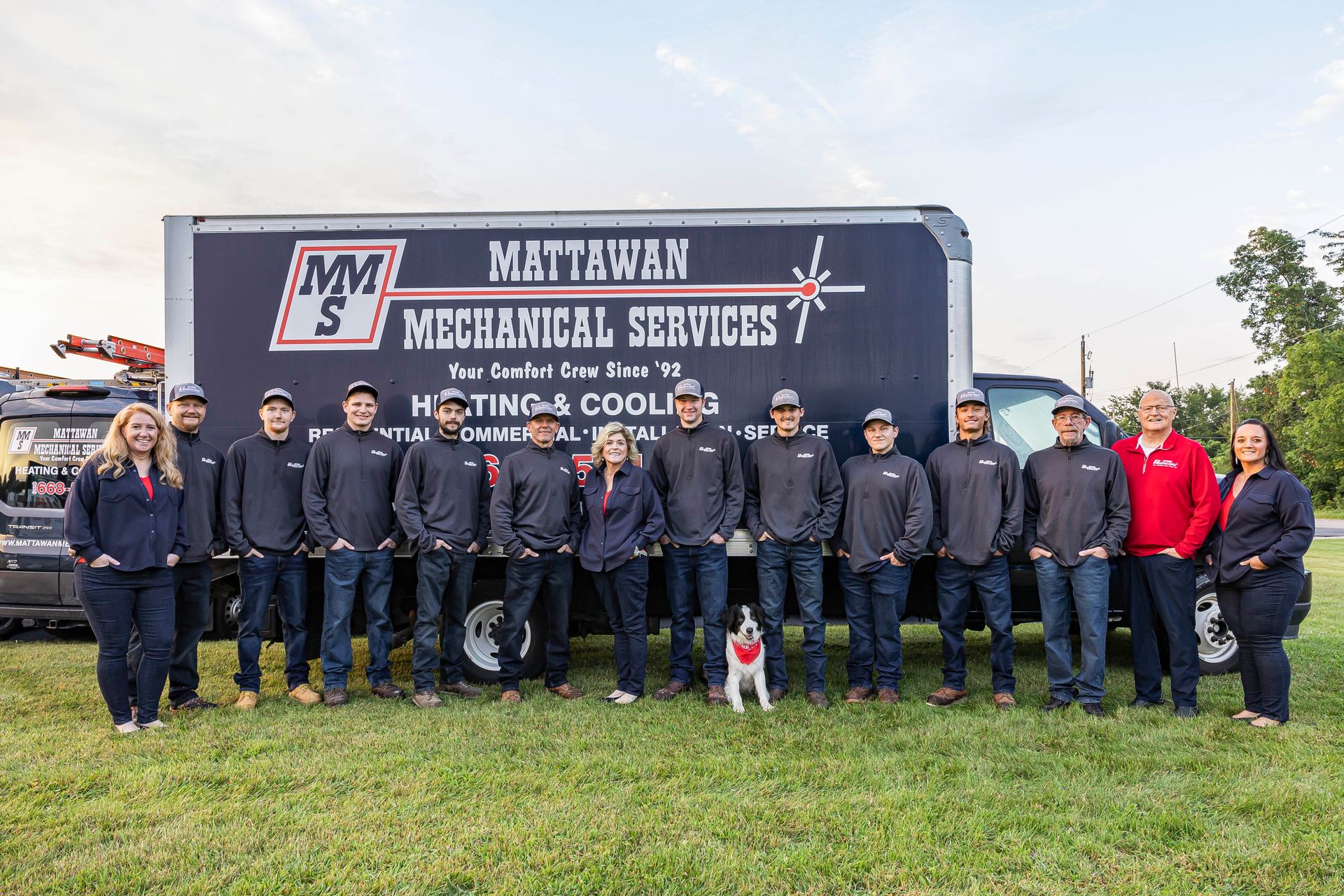 A group of people standing in front of a northwest mechanical services truck