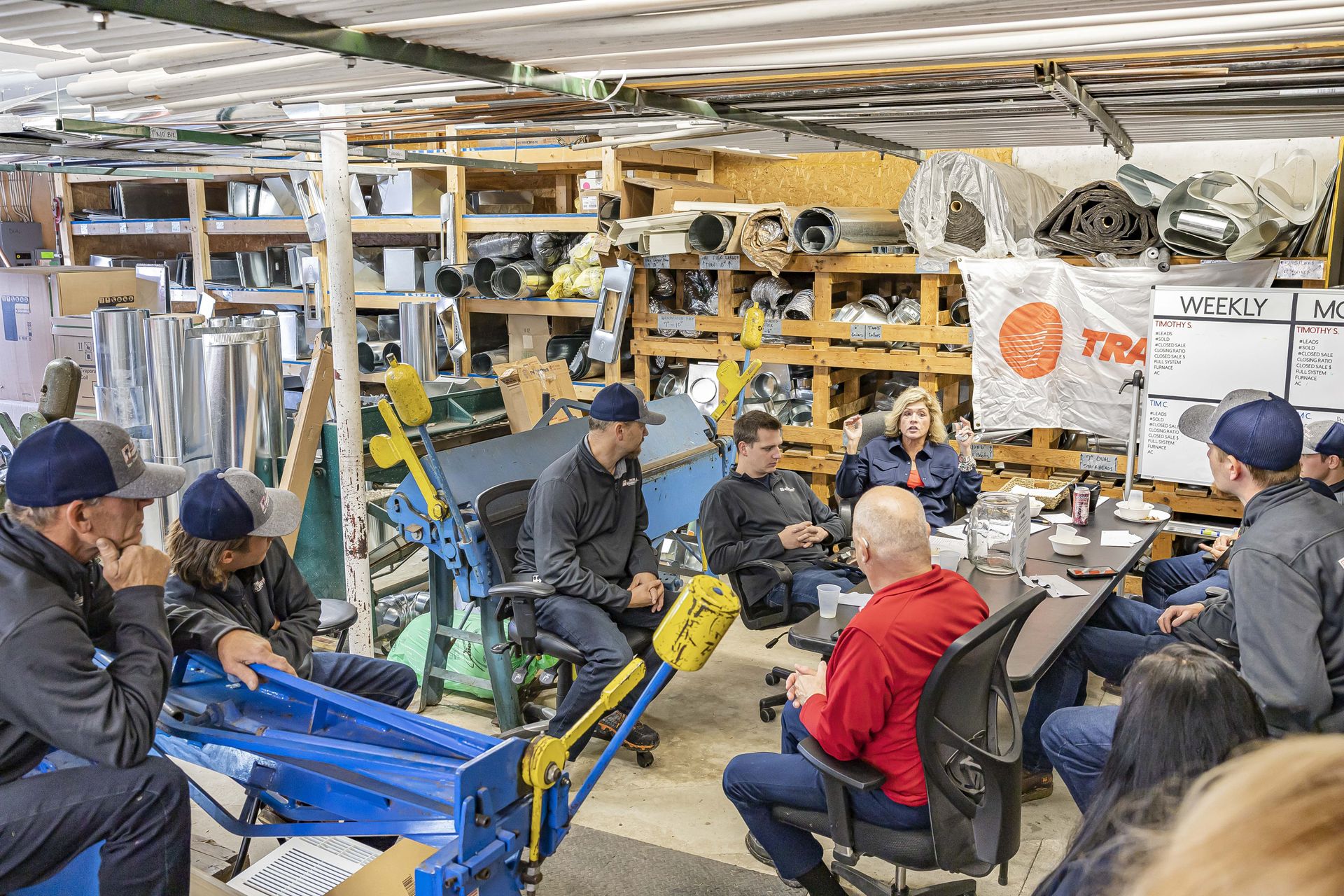 A group of people are sitting around a table in a room