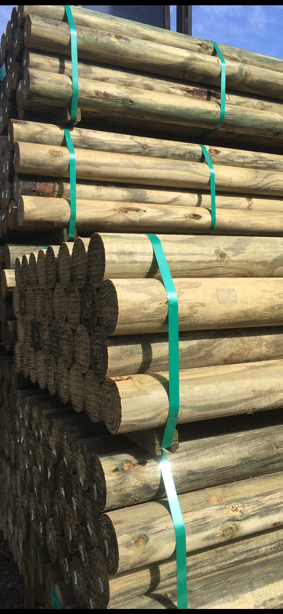 A Pile of Wooden logsStacked on Top of Each Other in A Warehouse — Gnomes Landscape & Garden Supplies In Old Bar, NSW