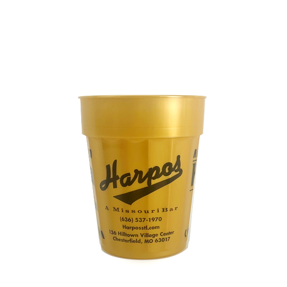 Gold Harpos bar cup with black logo, text, and contact info.