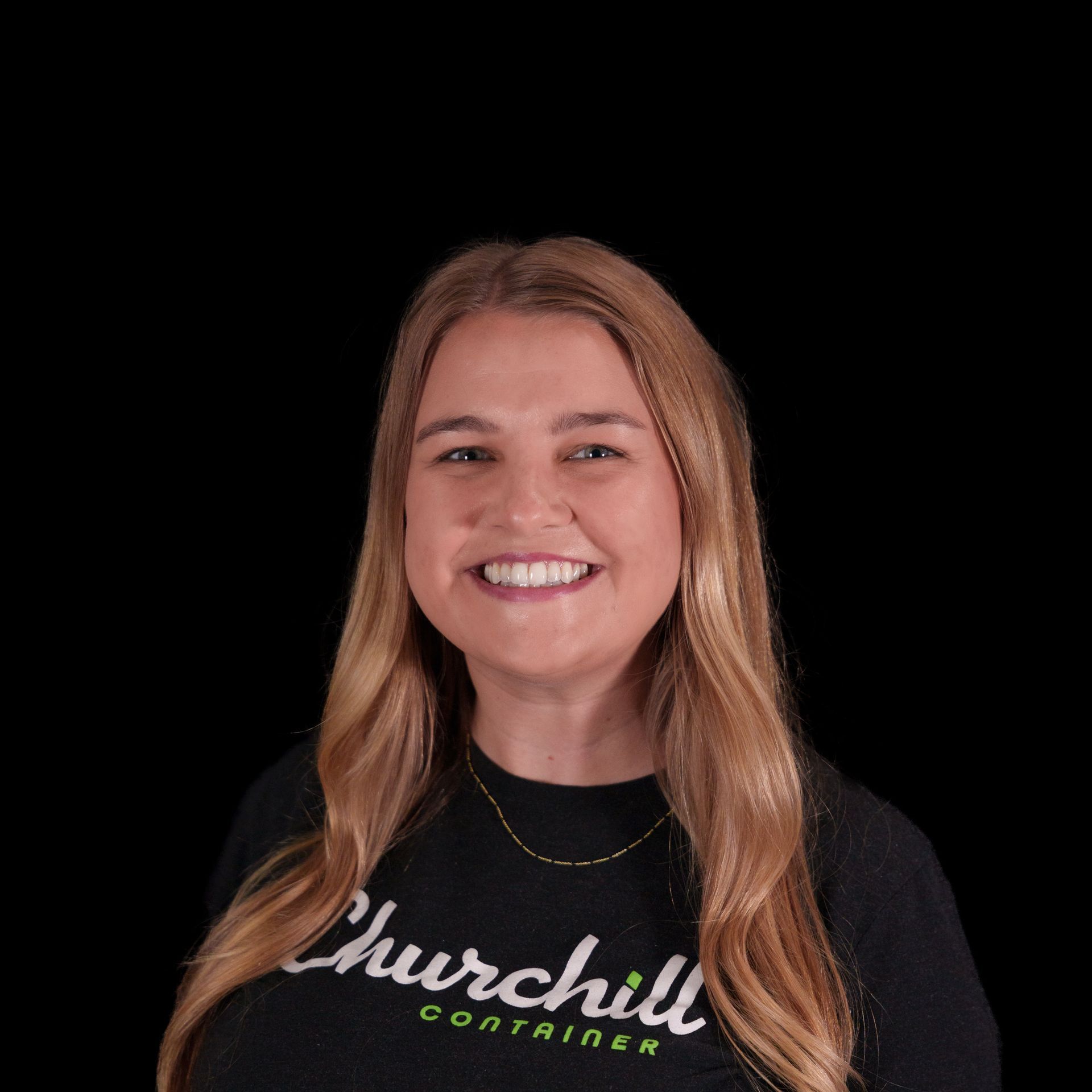 Woman with blonde hair wearing a black shirt that says 