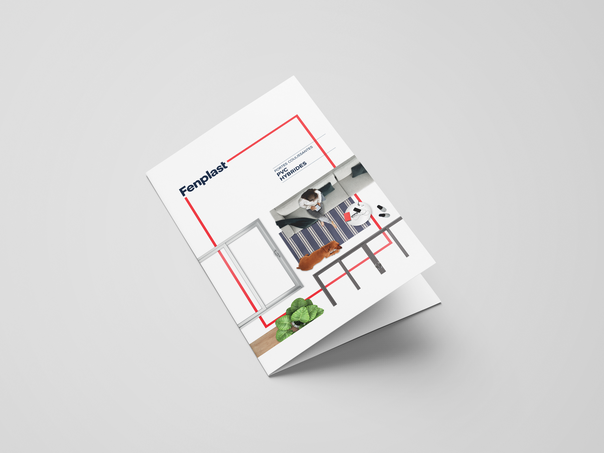 Une brochure ou un magazine incliné, à couverture blanche, avec des touches de rouge et une petite photo de décoration intérieure.