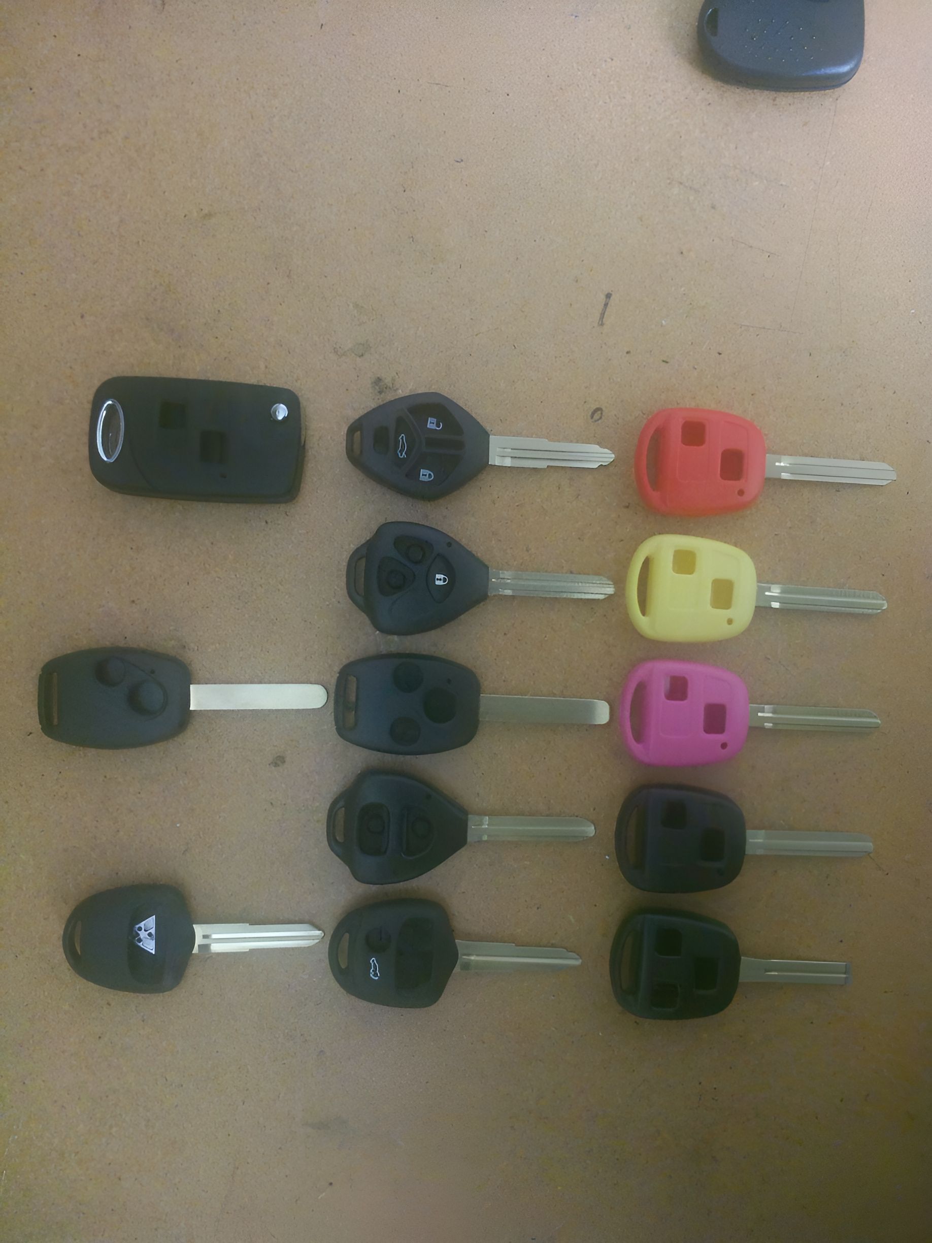 A Bunch of Car Keys Are Lined Up on a Table — ADC Locksmiths in Wollongong, NSW
