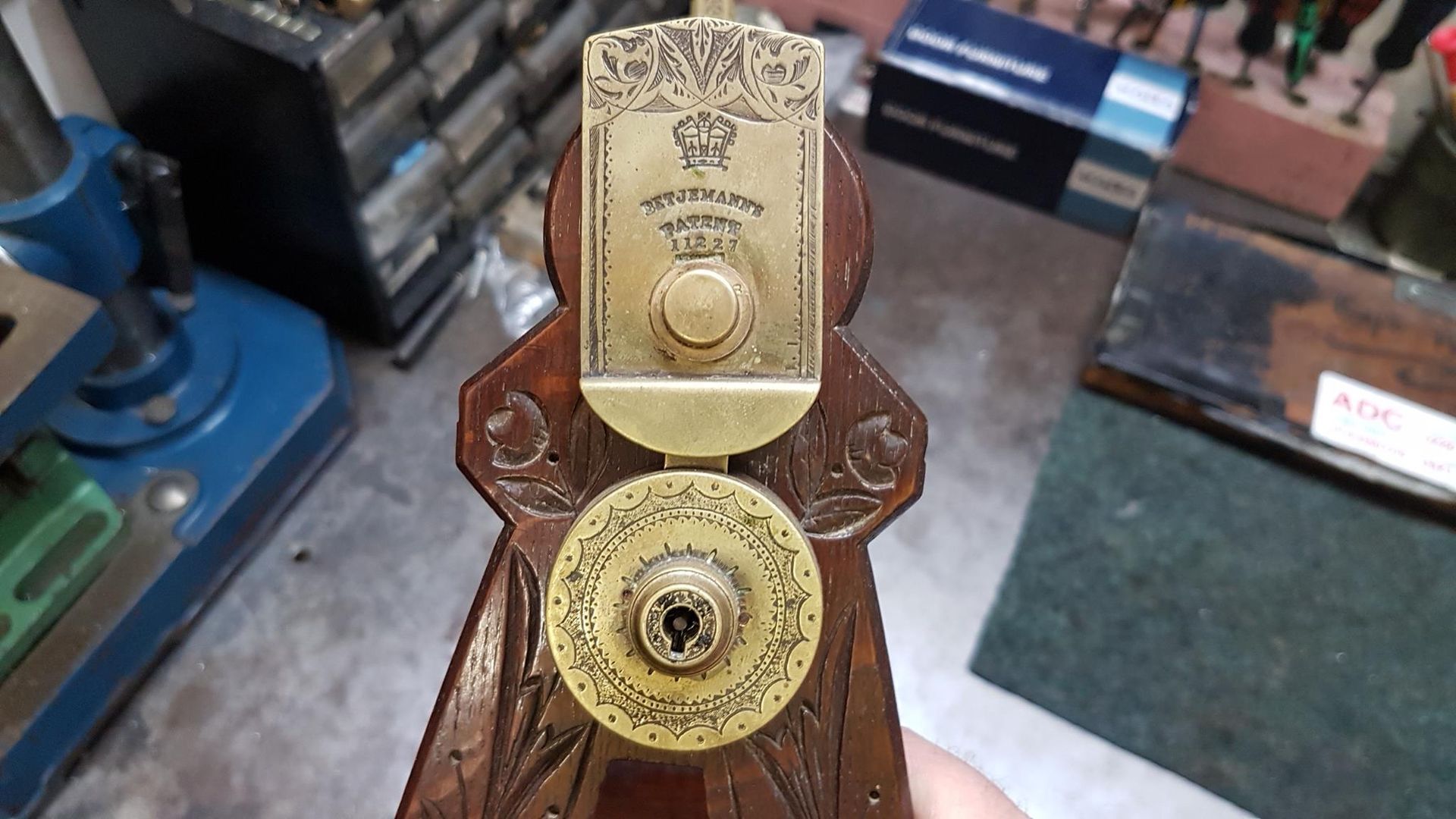 A Person is Holding a Wooden Object With a Key in It — ADC Locksmiths in Wollongong, NSW 