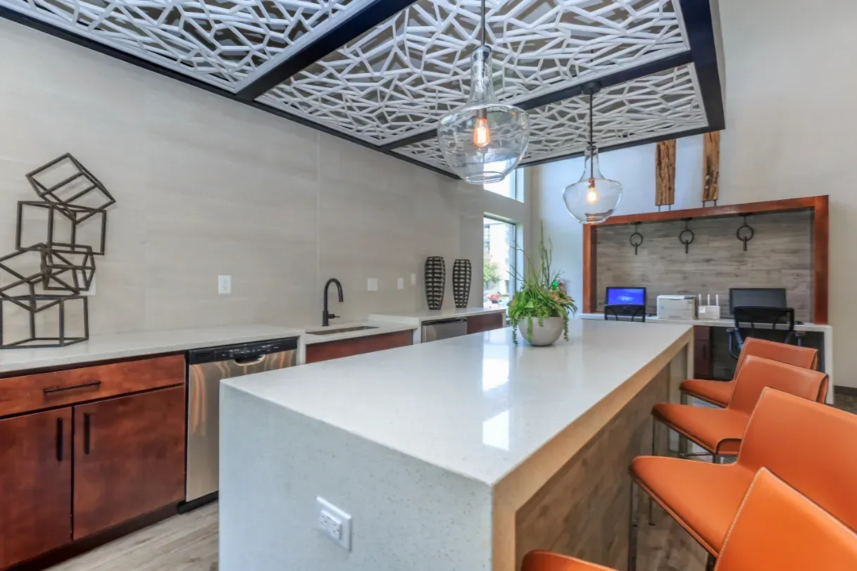 Kitchenette and work area with bar seating and computers.