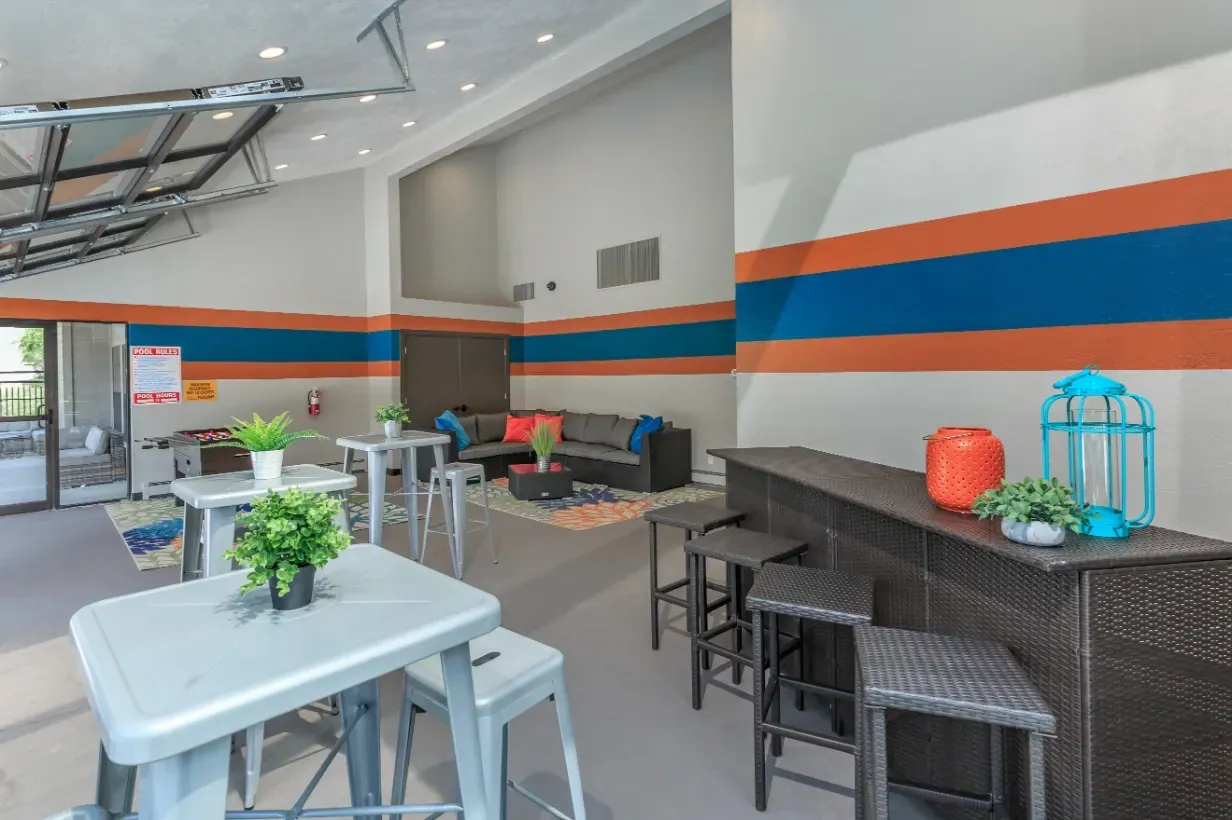 Community lounge with bar, high-top tables, foosball, and seating.