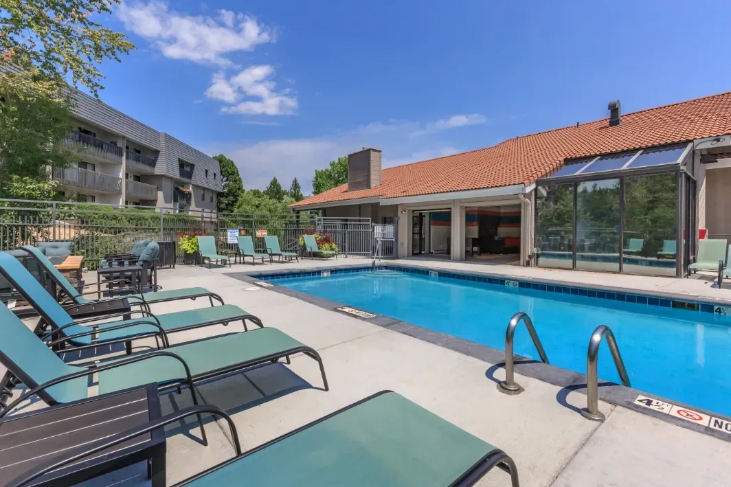 Resort-style swimming pool with lounge chairs and poolside cabana.
