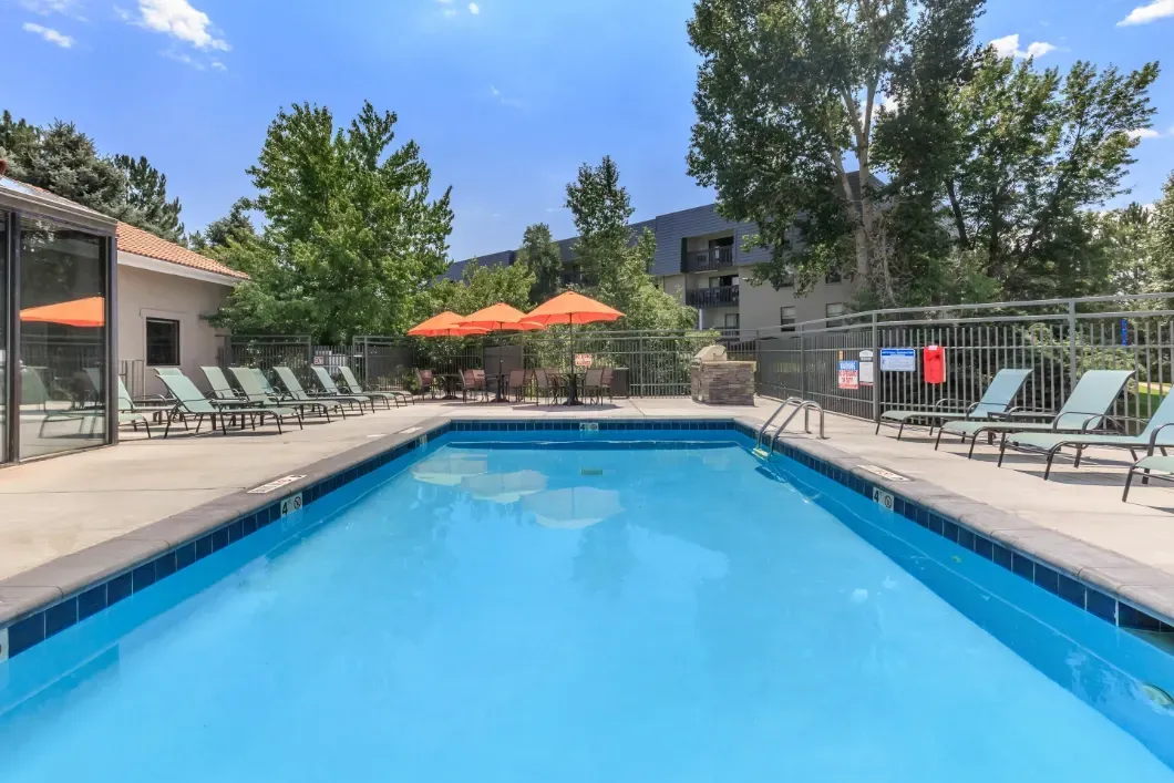 Outdoor swimming pool with lounge chairs and umbrellas