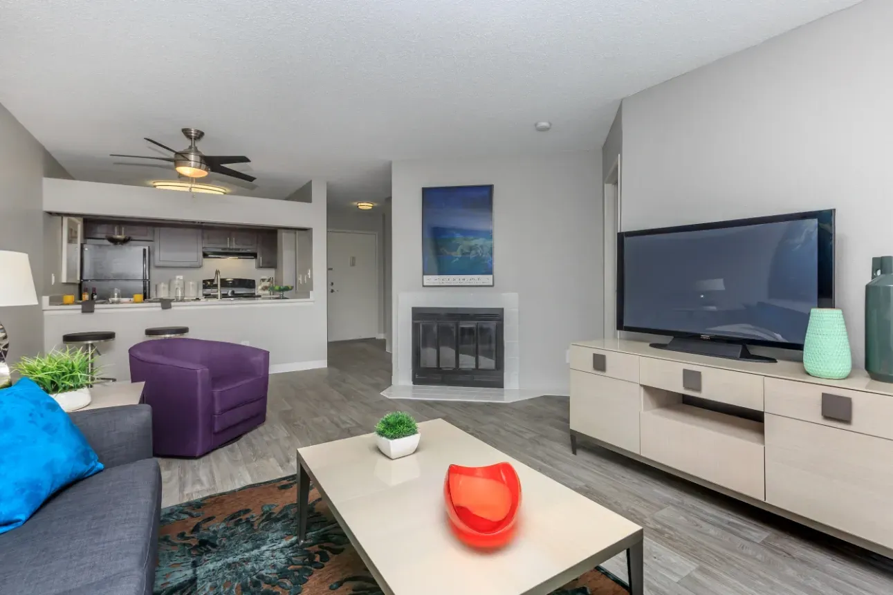 Living room with fireplace and kitchen view