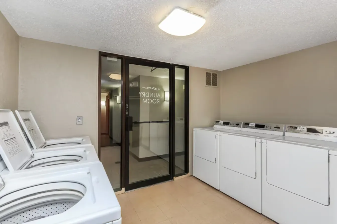 Laundry room with washers and dryers.
