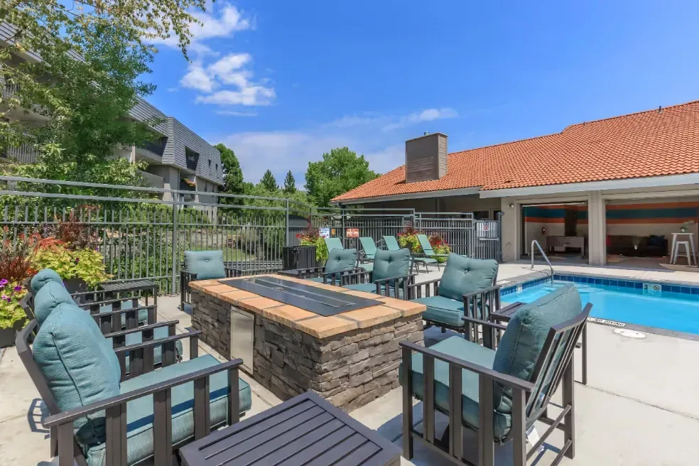 Outdoor pool area with fire pit and seating