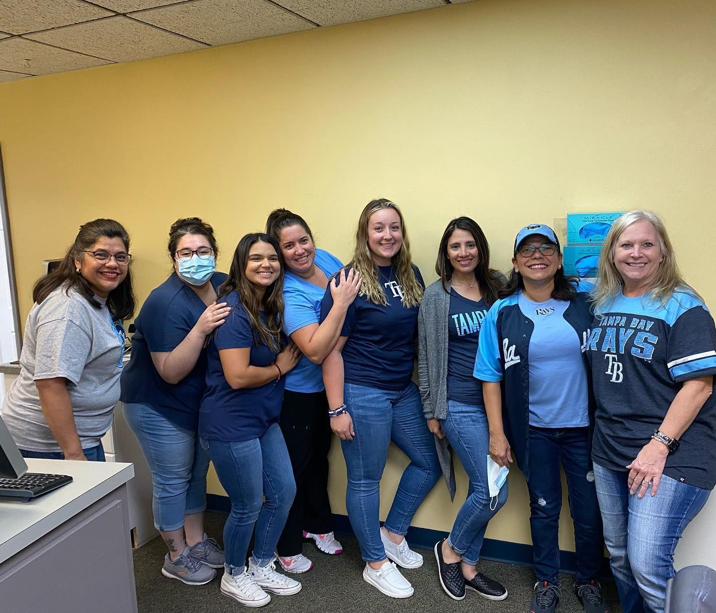 A group of women are posing for a picture in a room.