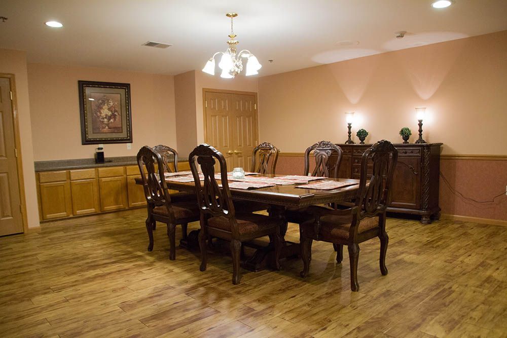 A dining room with a table and chairs and a chandelier.