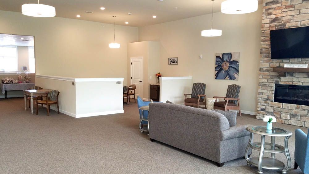 A living room filled with furniture and a fireplace.