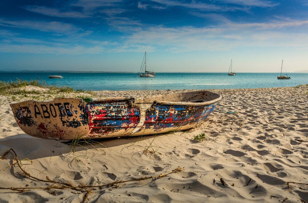 Old Row Boat Sits Discarded On The Sand — Bay Area Plumbing In Corlette, NSW